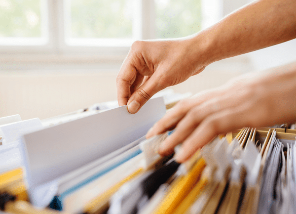 man pulling paper out from a folder