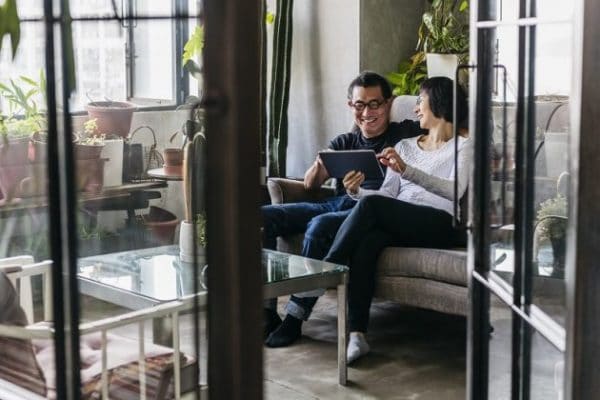 a middle adged couple sitting together in their sun room