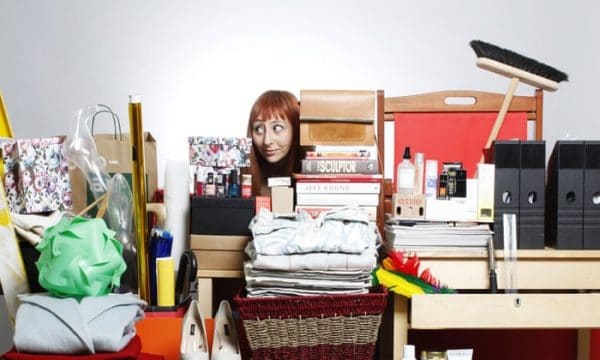 a woman looking at all her clutter on the table