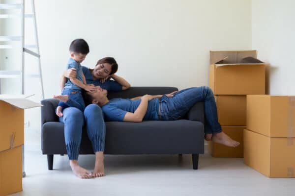 a happy asian family bonding in their empty living room