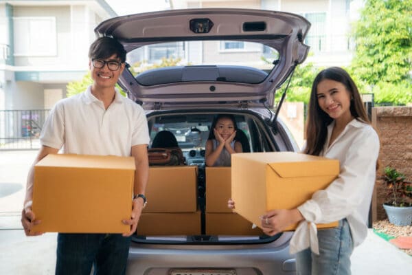 a family moving boxes in their car