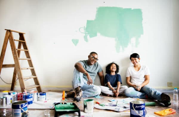 a young family sitting on the floor of their living room during renovation