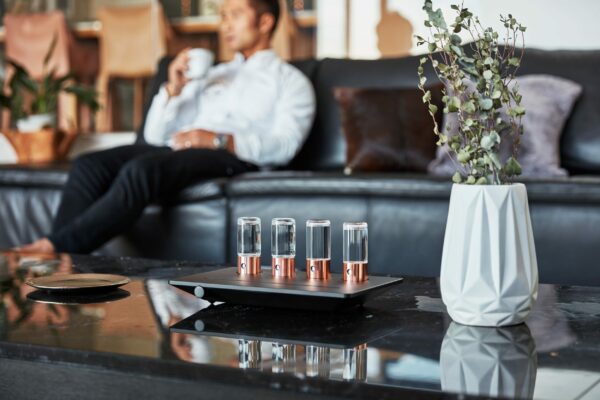 a man sitting on his couch while drinking coffee