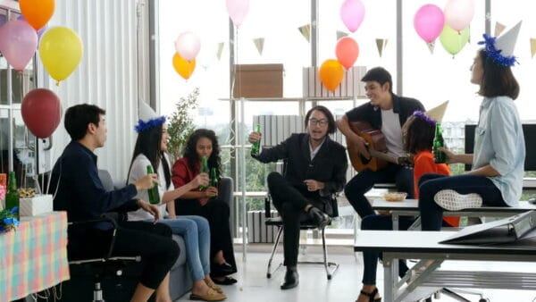 a group of co-workers having fun in an office party