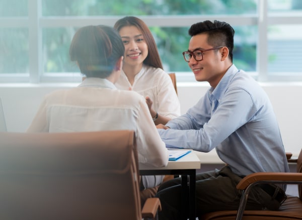 colleagues discussing at their desks