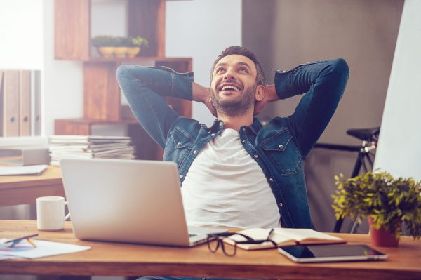 a man feeling relieved while he works from home