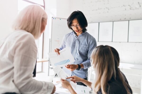 a man explaining a chart to his colleagues
