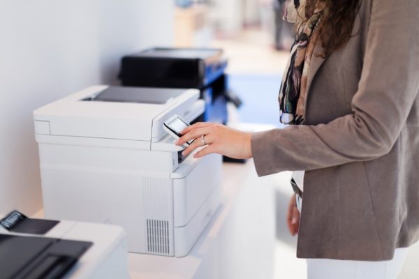 a woman in the office using the company printer