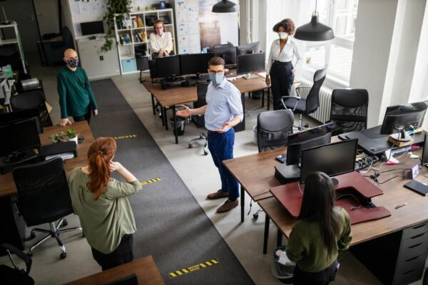 Office workers social distancing in a working space