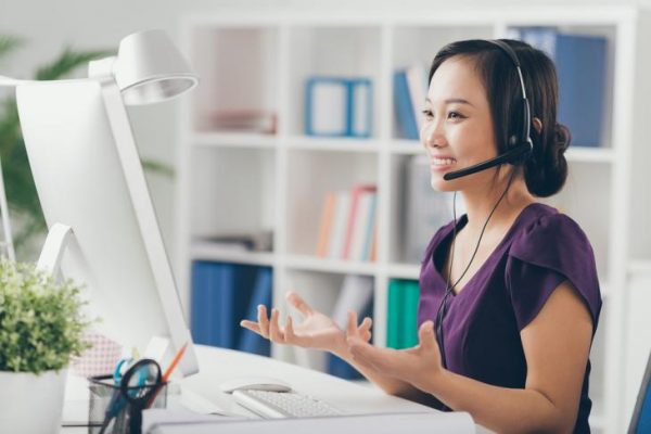 an asian woman working from home as a customer service representative